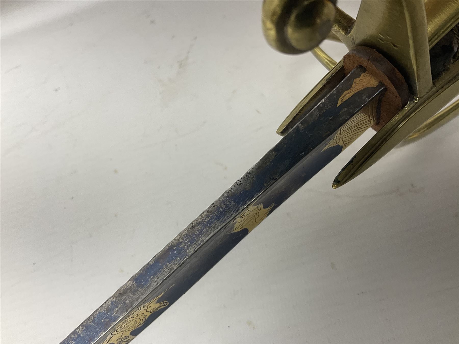 Early 19th century French Lancers officer's sword c1810, the 84cm curving fullered blade retaining most of its bluing, gilding and engraved decoration, inscribed I.S.& C. to ricasso (for Schimelbusch), brass three-bar hilt with elongated elliptical langets and wire-bound leather grip; in polished steel scabbard with two brass suspension rings L100cm overall