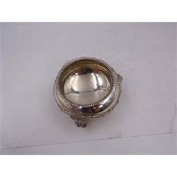 Early 20th century silver open sucrier, of circular form, with fluted gadrooned rim and decorated in relief with floral swags, united by three lion mask mounts and upon three paw feet, hallmarked Z Barraclough & Sons, London 1912, H6cm, D11cm, with similar spoon with lion mask finial, hallmarked London 1912, maker's mark indistinct