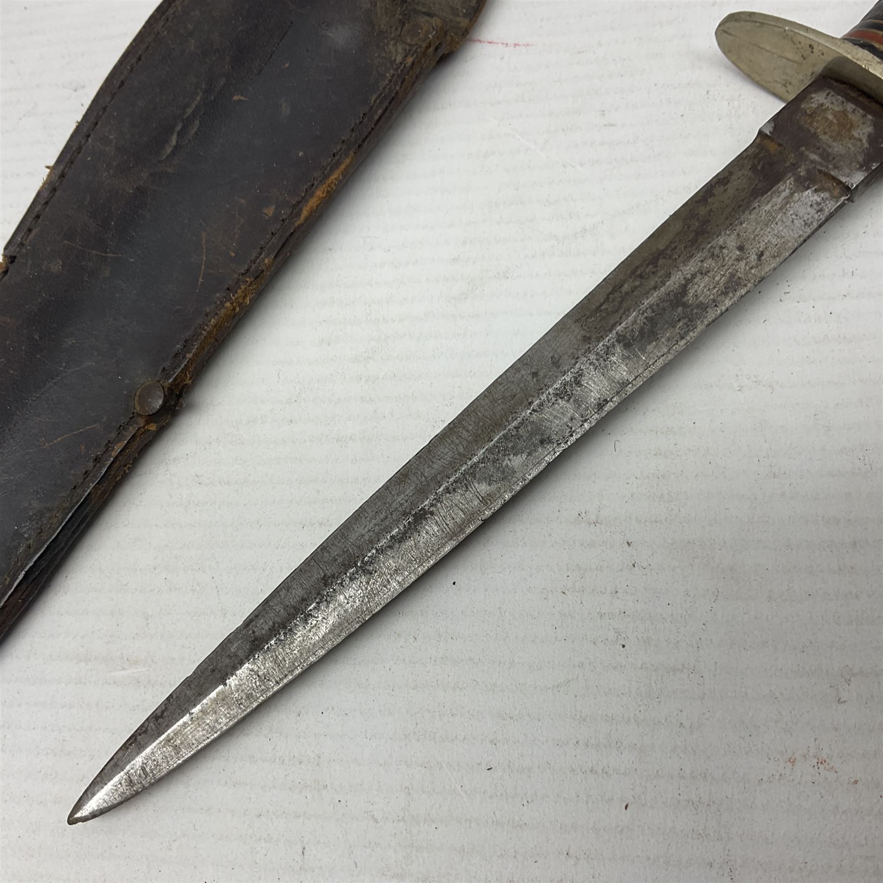  British Private Purchase fighting knife by William Rodgers, Sheffield, the 15cm double edge steel blade with raised medial ridge, stamped on one side of the ricasso WILLIAM RODGERS I CUT MY WAY, the opposing side marked MADE IN SHEFFIELD, ENGLAND, with aluminium crossguard and pommel, stacked leather washers grip and leather scabbard L27.5cm overall; and a crudely made short sword with 32.5cm single edged blade and steel knucklebow hilt with hardwood grip; in cane bound wooden scabbard L45cm overall (2)