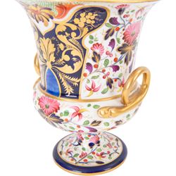 Derby twin handled campagna urn, decorated with flowers and cobalt panels highlighted in gilt, together with a smaller example with similar decoration, tallest H20cm