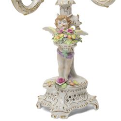 Pair of German porcelain three branch candelabra, the based modelled with putti holding flowers, printed blue mark to base, H35cm (2)