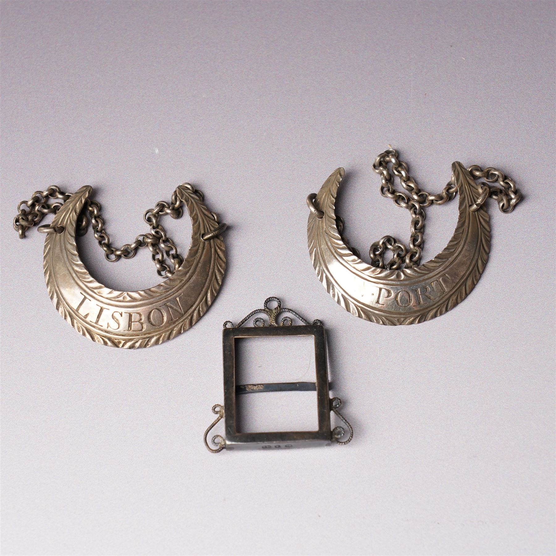 Glass whisky noggin with silver hinged cover and clear glass handle H10cm Birmingham 1921 Maker Hukin & Heath, a pair of early silver decanter labels 'Lisbon' and 'Port' and a small silver frame 