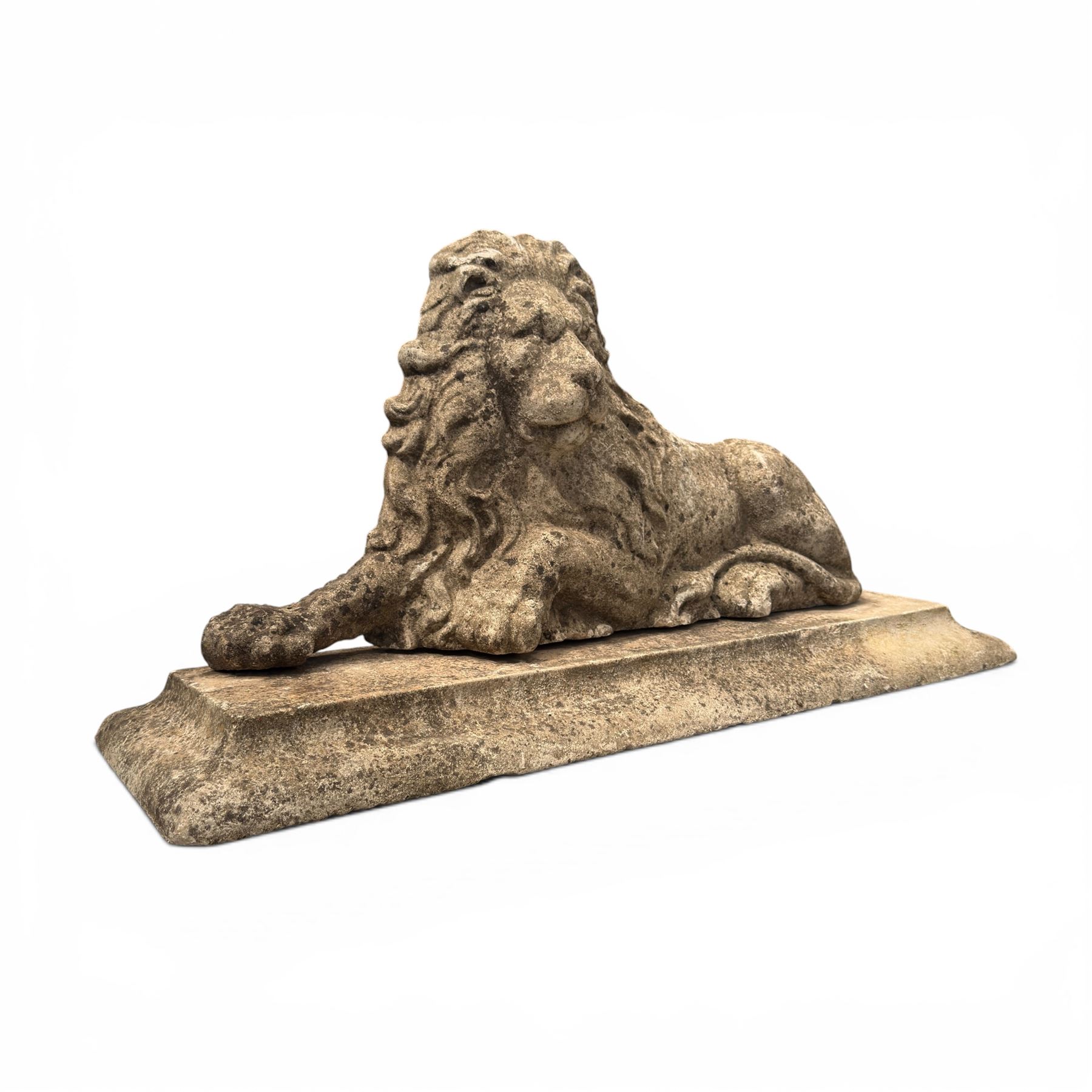 Neoclassical design cast stone garden lion, modelled recumbent with raised and flowing mane, on rectangular plinth base, with flat plain reverse, in weathered finish