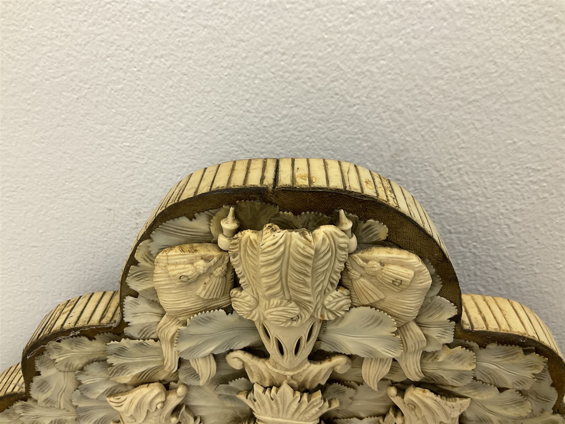 Pair 19th century French Dieppe bone and ivory wall mirrors, the oval bevelled mirror plates within rectangular frames with shaped tops, profusely decorated with ivory leaves, further detailed with carved bone armorial type crest inscribed 'SGOTORVM', putti, fish and mask heads, H81cm W48cm