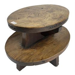 20th century figured elm occasional table, two oval tiers raised on cruciform base, the top tier carved with incised decoration 