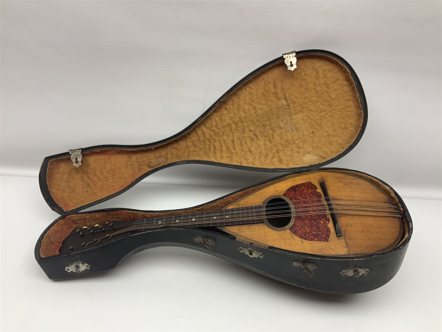Late 19th century Italian lute back mandolin with segmented bowl back, bears label Gennaro Maglioni Napoli L61cm; in ebonised wooden case; together with another similar damaged Italian lute back mandolin for restoration or spares (2)