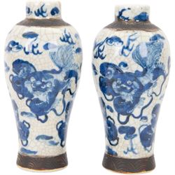 Pair of 20th century Chinese crackle glaze vases, of baluster form, decorated with dogs of foo amongst clouds, H23cm