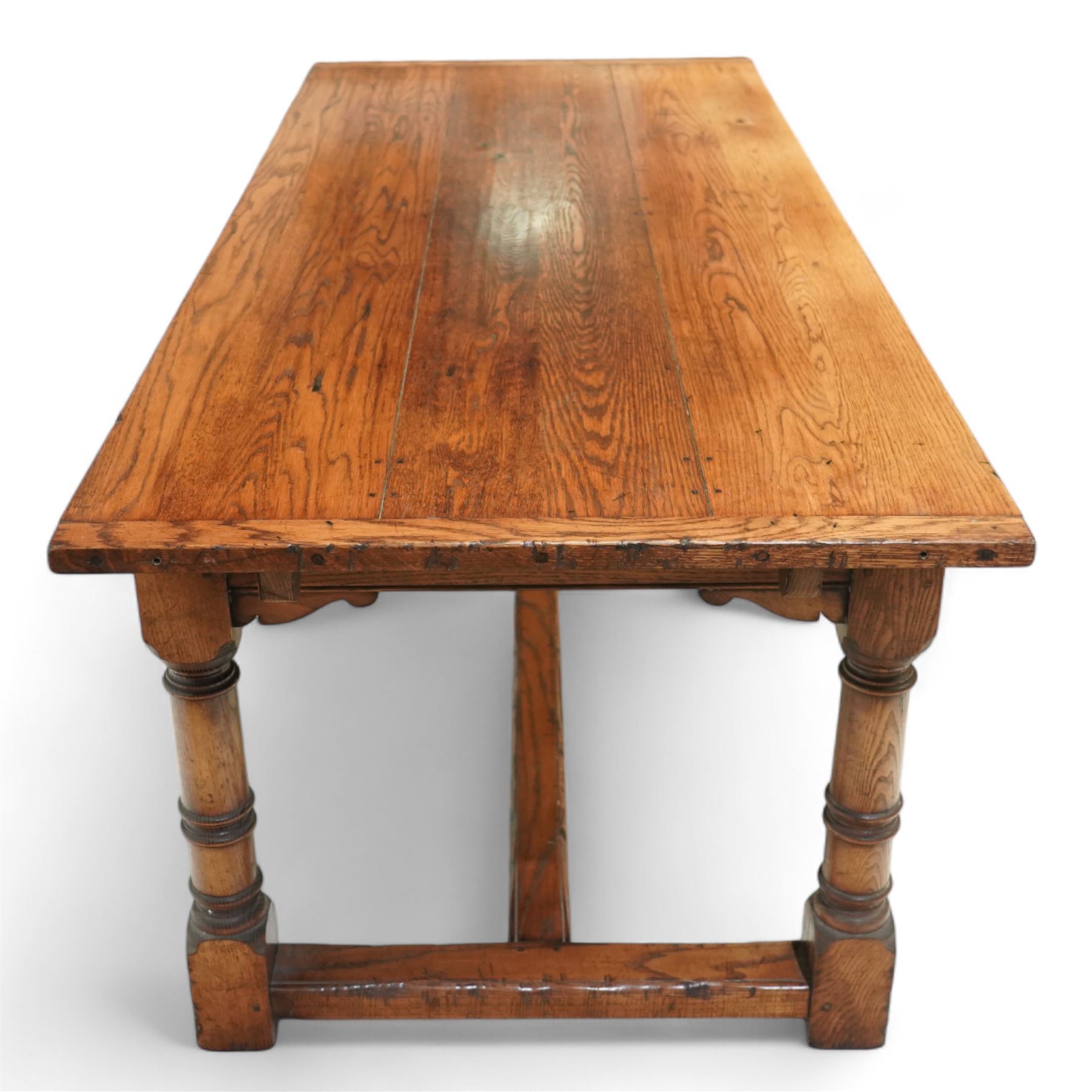 Late 20th century oak refectory table in 17th century style, with plank top and end leaf, raised on ring turned baluster legs with square feet, joined by conforming stretchers (260 cm extended)