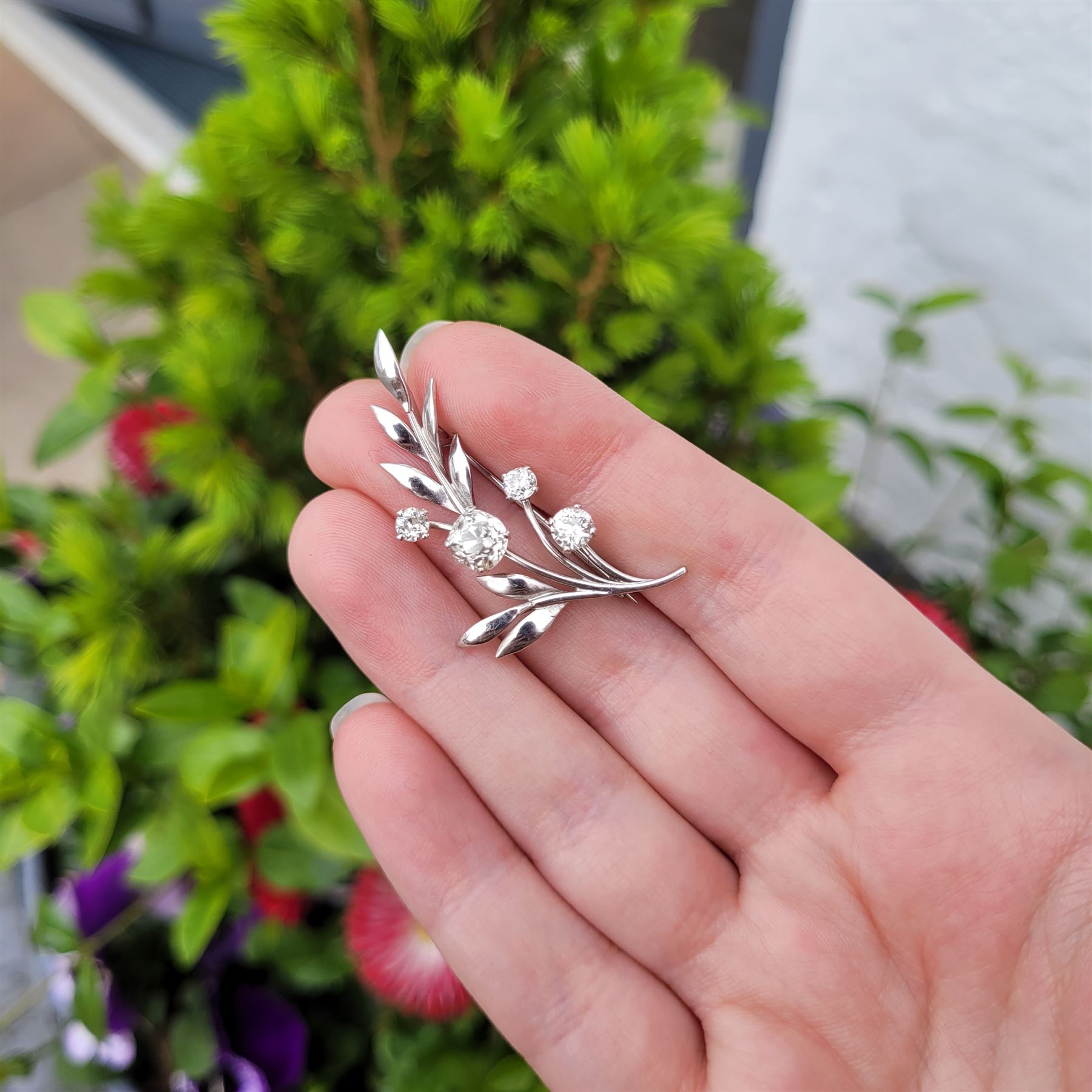 18ct white gold diamond flower brooch, set with a principal old cut diamond of approx 1.00 carat, surrounded by three further old cut diamonds, total diamond weight approx 1.75 carat