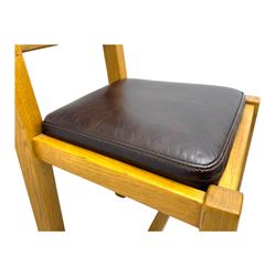 Contemporary oak dining table, rectangular panelled top with integral extension leaf, raised on square supports; set of four oak ladder-back chairs with padded brown seats
