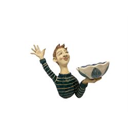 Ceramic 'girl and boy dish', by Helen Kemp, an oval dish with a mottled pink ground and gilt edging upon the sculpted heads of a girl and a boy, together with a 'boy sconce', by Helen Kemp, a sculpted boy holding a small bowl with foliate decoration, both with the artist's mark beneath.