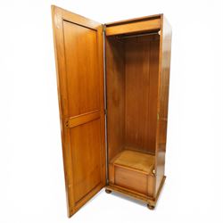 Late 19th century Arts & Crafts stained pine single hall wardrobe, single panelled door with brass fittings enclosing sliding tray to top with hanging rail and hooks, hinged box seat to base, on compressed bun feet