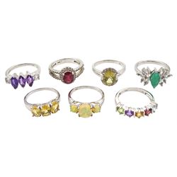 Seven silver stone set rings including emerald and topaz, amethyst, opal, ruby and white topaz, citrine and quartz, all stamped