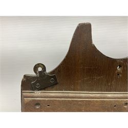 George III oak spoon rack and candle box, the rectangular backplate with shaped  pediment and two six aperture spoon racks, above a candlebox with hinged cover, with various brass spoons and a pair of brass candle snuffers, H56.5cm, W35cm, D14cm 