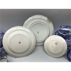 Spode blue and white Italian pattern dinner and tea wares, comprising five dinner plates, four side plates, seventeen side plates, four bowls, ten tea cups and twenty one saucers, five coffee cans and six saucers, and a flan dish, with blue and black printed marks beneath 