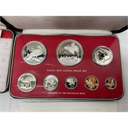 Four Papua New Guinea proof eight coin sets, from ten kina to one toea, comprising First Coinage of Papua New Guinea 1975 proof set, 1976, 1977, and 1979 proof sets, the 1977 and 1979 sets containing 925 silver ten kina and 500 silver five kina coins, all minted at the Franklin Mint, cased with certificates (4)