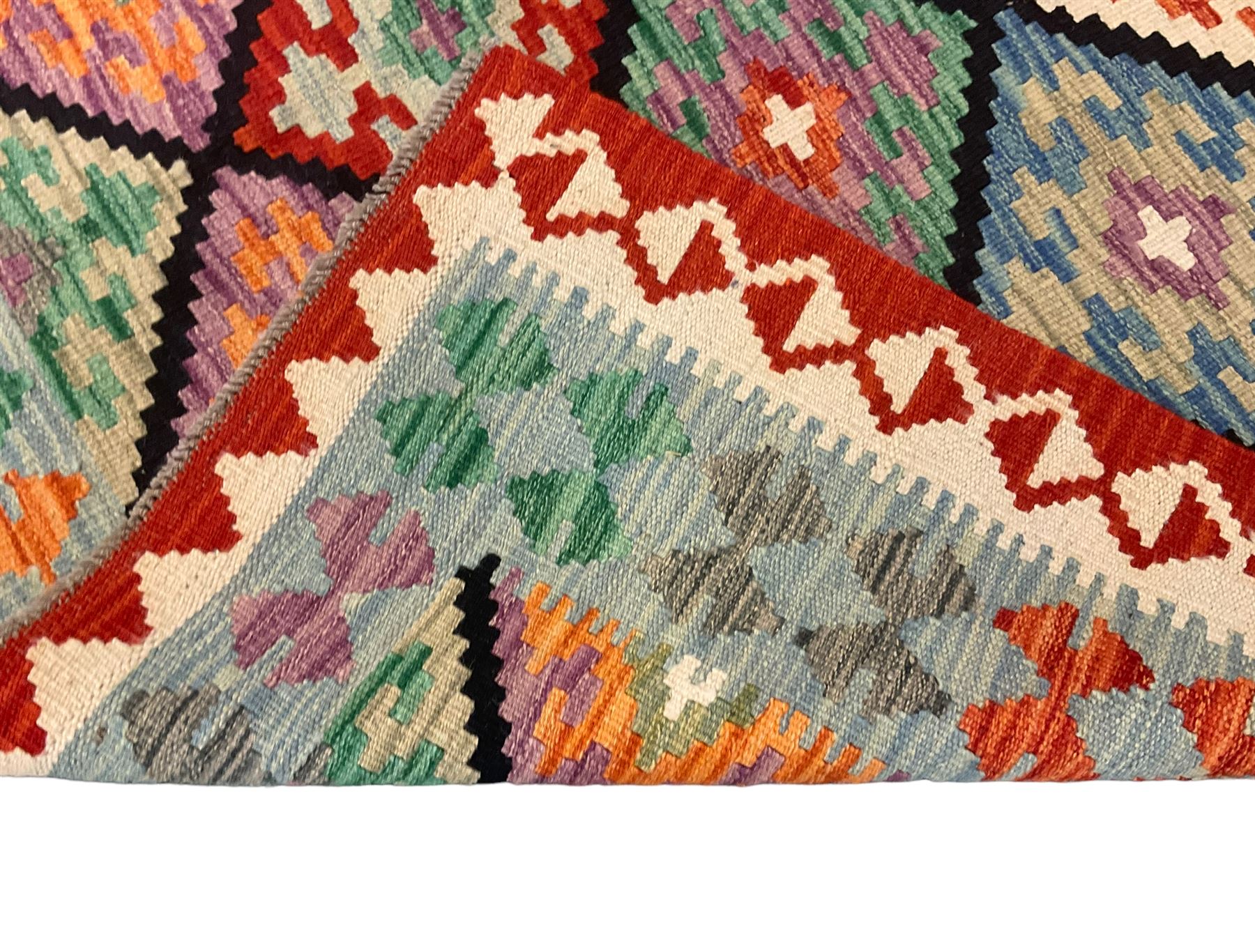 Anatolian Turkish Kilim multi-colour rug, decorated with all over lozenges in contrasting colours with dark indigo outline, the multi-band ivory and red border with repeating geometric shapes and small lozenges or diamonds