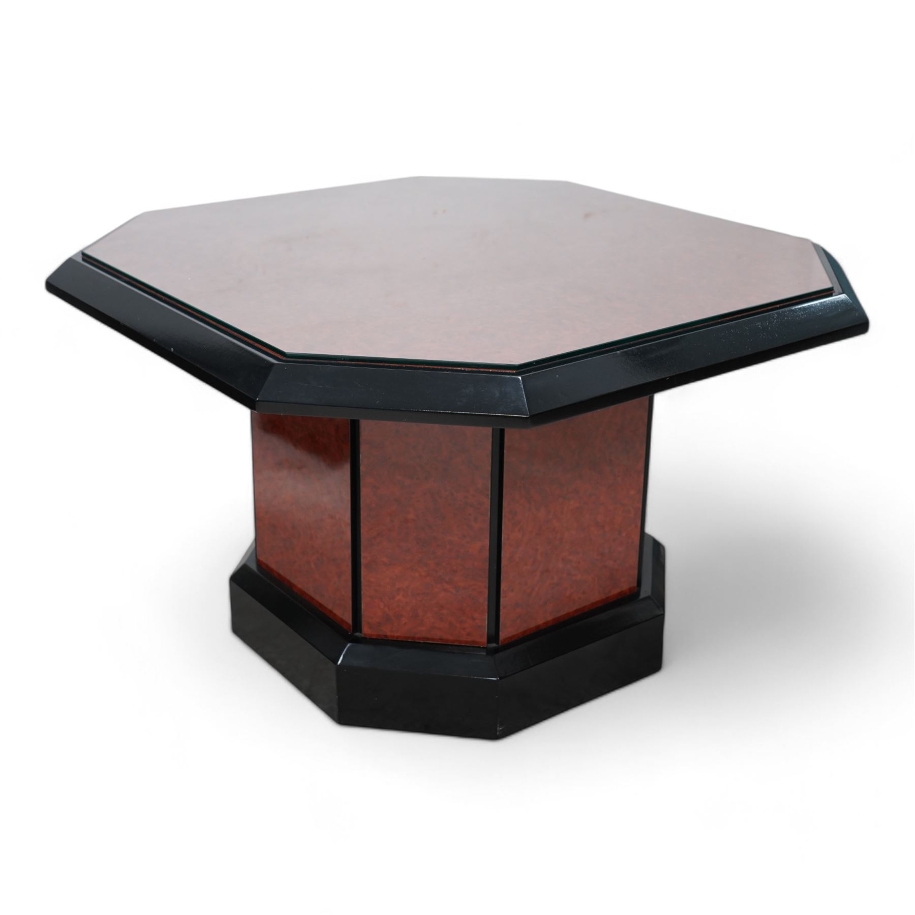 1980s figured wood finish and black lacquered coffee table, square canted top with chamfered edge, on canted pedestal with plinth base 