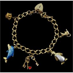 Gold curb link bracelet, with five gold charms including penguin, enamelled dolphin, crown, mouse and set of keys, all 9ct stamped, hallmarked or tested