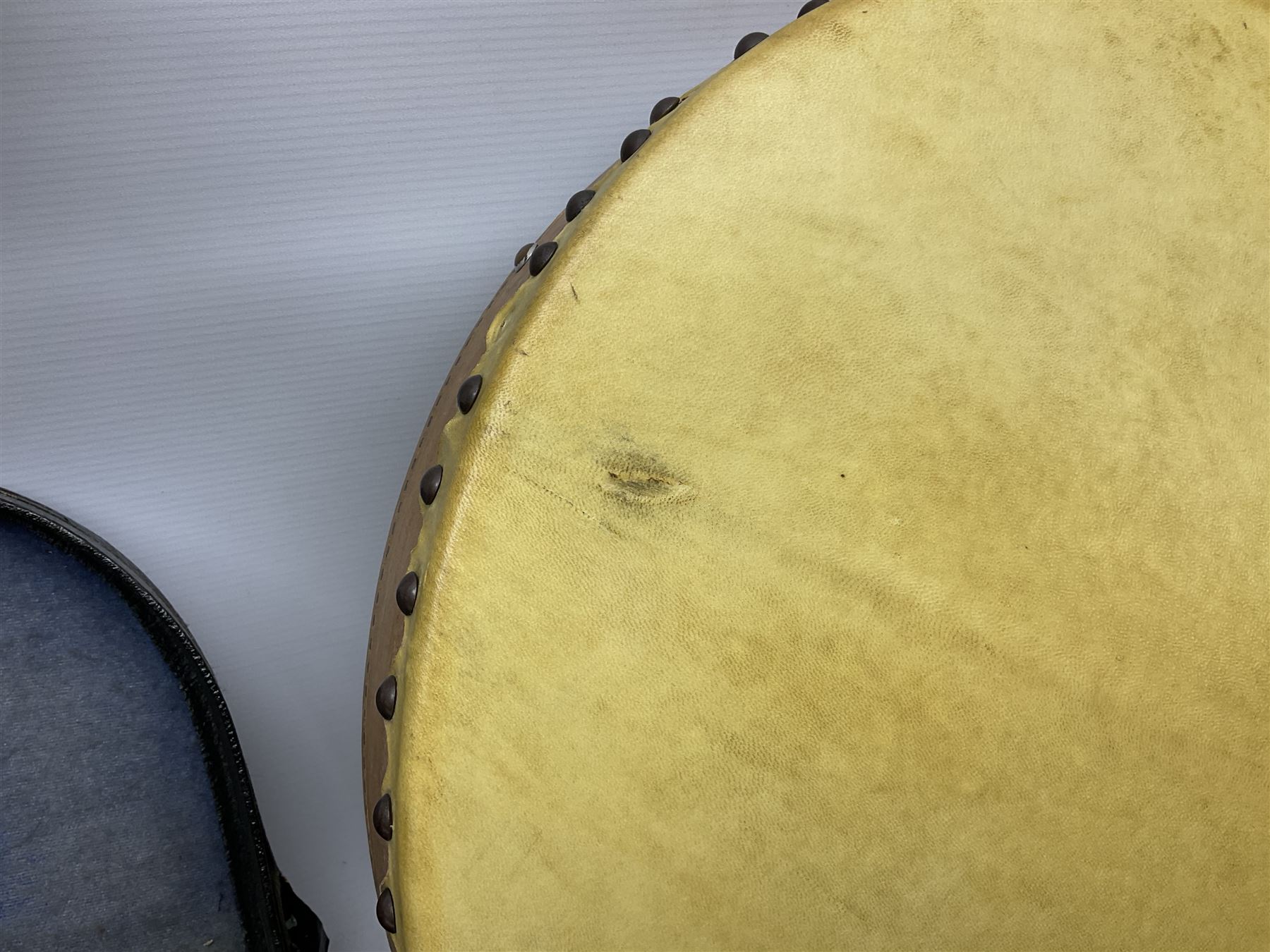 Dulcet eight-string banjo mandolin with mother-of-pearl inlaid ebonised fingerboard L55.5cm; cased; and Irish mahogany bodhran hand drum with inlaid stringing and vellum top D46.5cm; in soft carrying case with double ended beater (2)