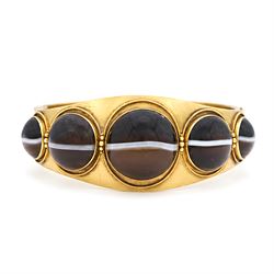 Victorian gold banded agate hinged bangle, set with five graduating cabochon cut agates, s...