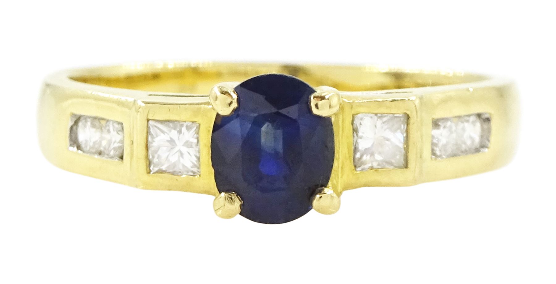 18ct gold sapphire and diamond ring, single oval cut sapphire of approx 0.70 carat, with a princess cut diamond and two round brilliant cut diamonds set either side, stamped 750, total diamond weight approx 0.20 carat
