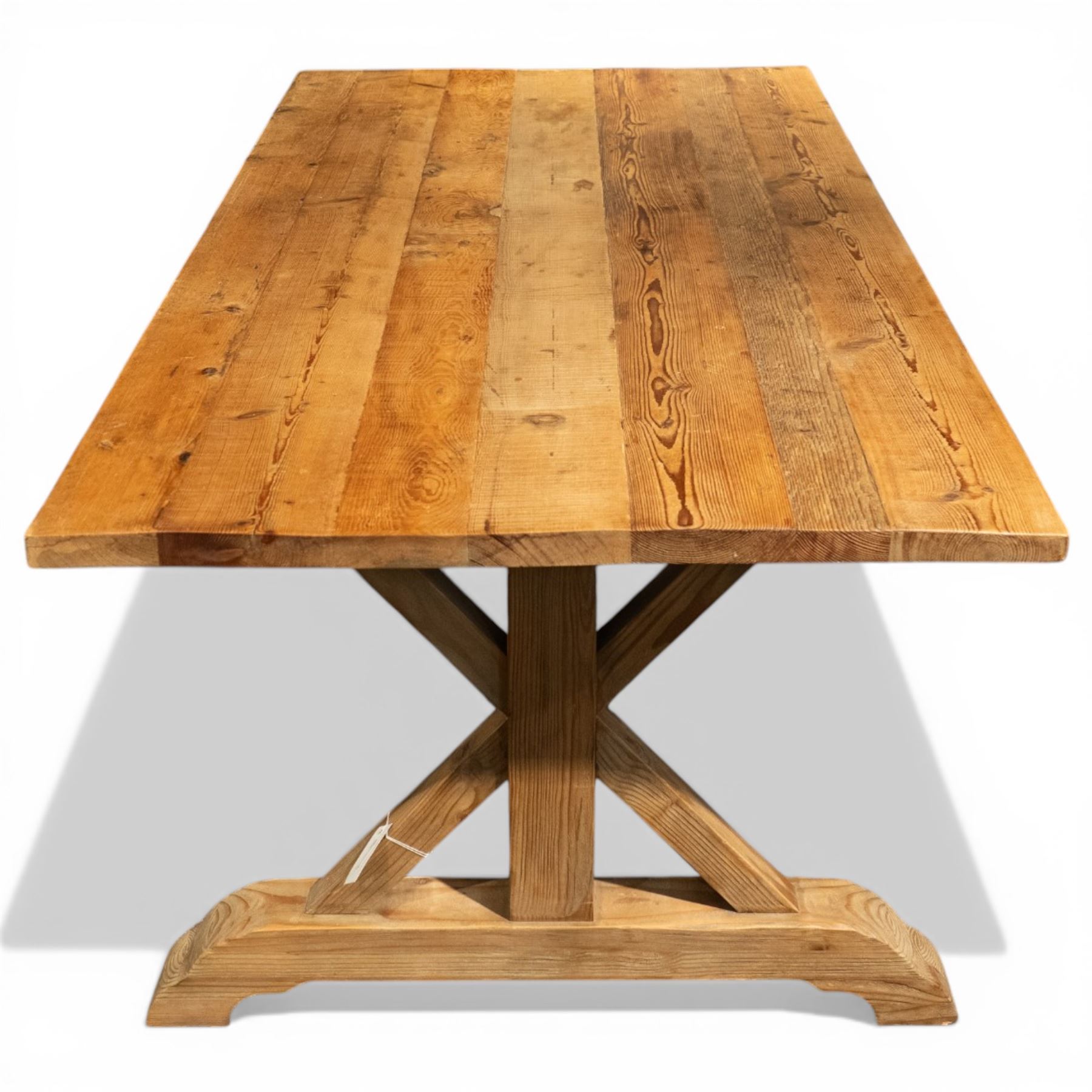Pine country x-framed dining table, a rustic plank top raised on two x-framed supports