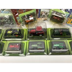 Eighteen issues of Tractors and The World of Farming magazine, together with sixty diecast tractors, all in original packaging, in three boxes 