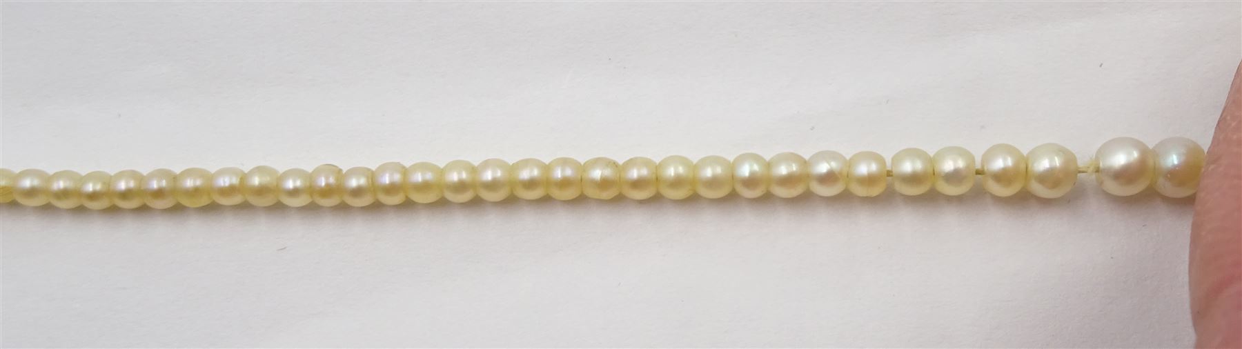 Three strand pearl necklace, with platinum diamond milgrain clasp and a single strand graduating pearl necklace with 18ct white gold clasp set with a diamond