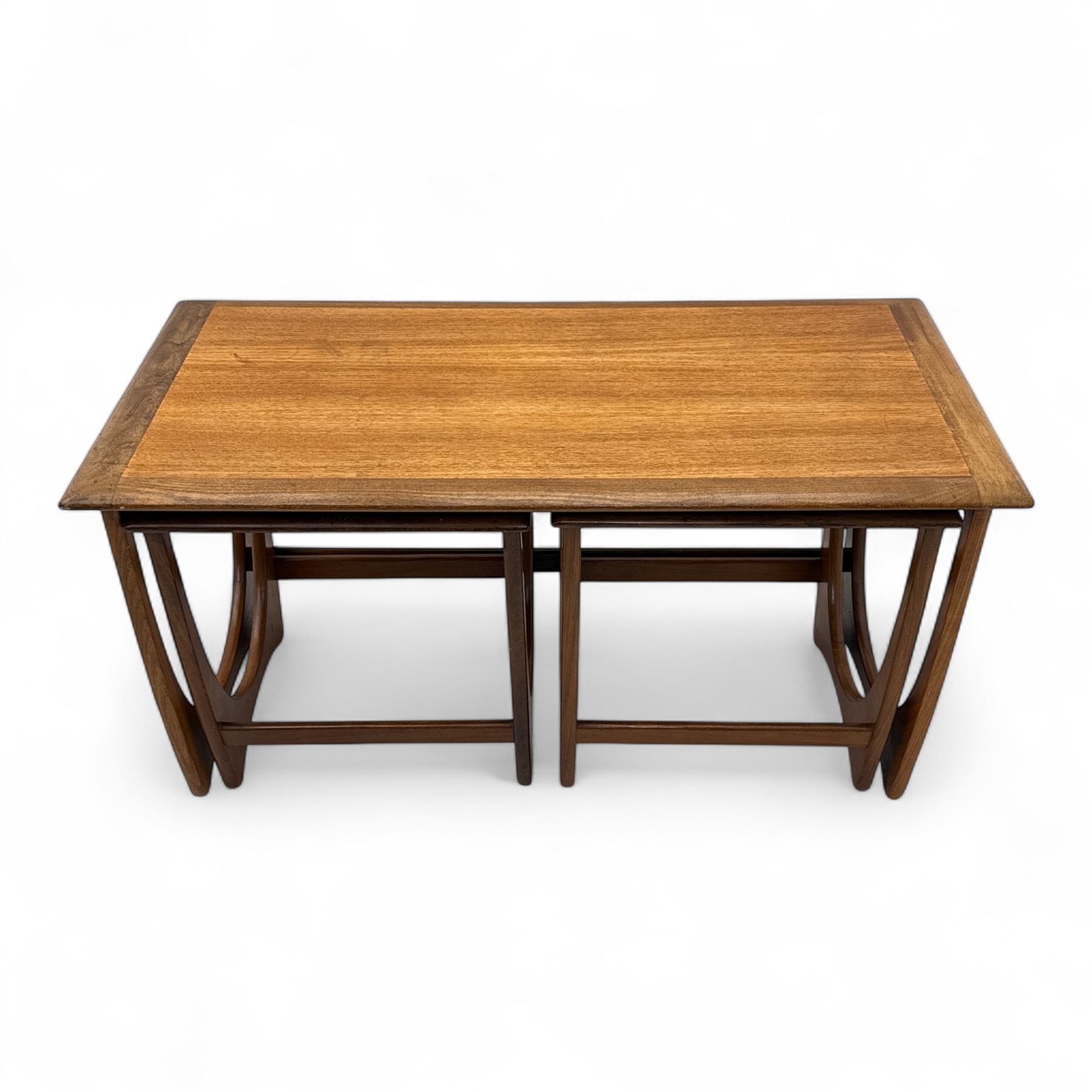 G-Plan - 'Astro' mid mid-century long teak coffee table with two nesting tables, rectangular top with outer banding, above two square top occasional tables on U-shaped end supports united by a stretcher