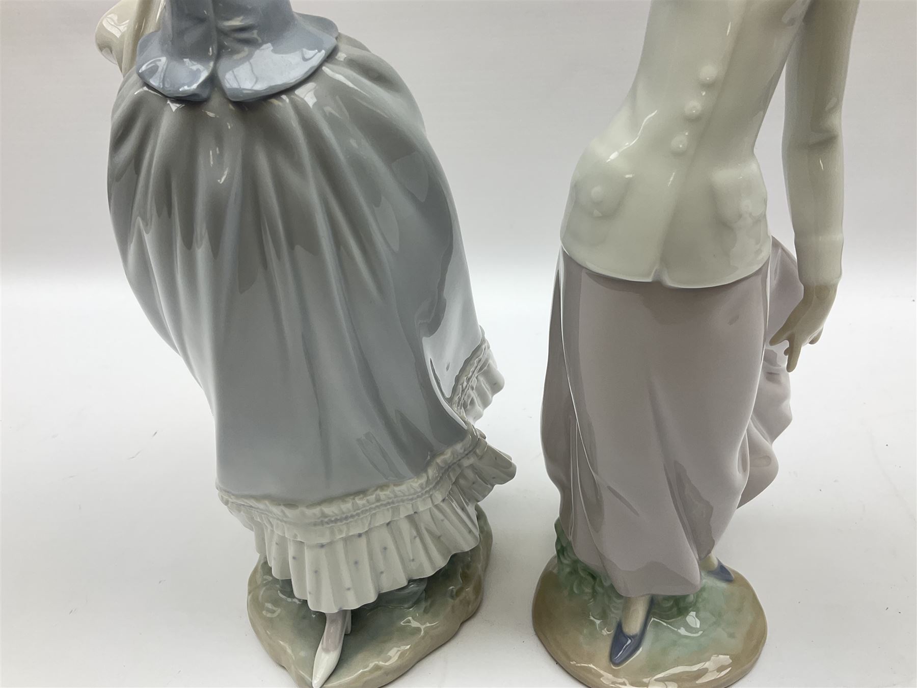 Three Lladro figures, comprising, Dreams of Summer Past no 6401, Spring Breeze no 4936 and Breezy Afternoon 5682 together with Lladro plaque Art Brings us Together no 7677, all in original boxes, largest example H35cm