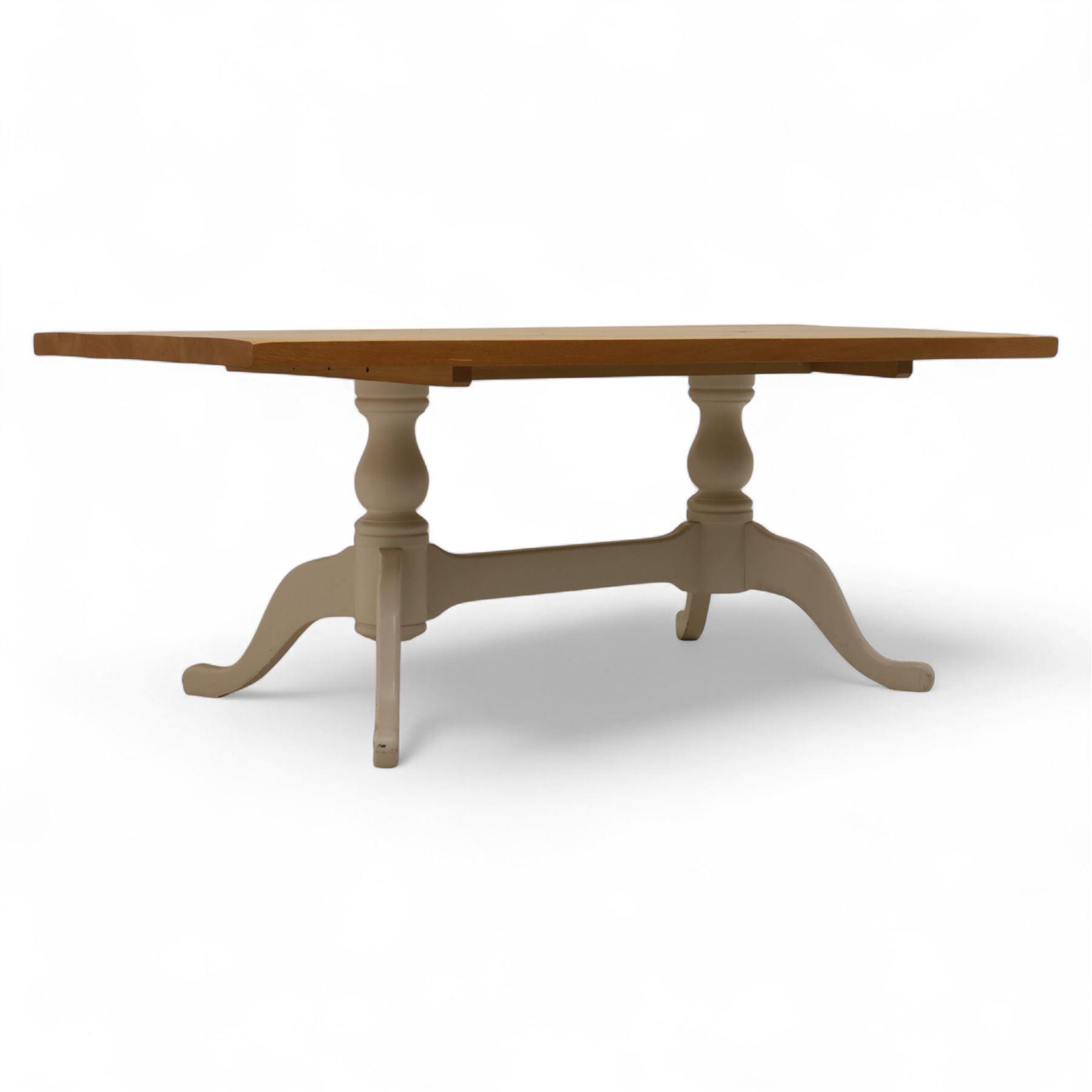 Contemporary light oak dining table, painted tripod bases with stretcher 