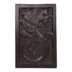 19th century oak panel, the center carved with a mythical creature 
