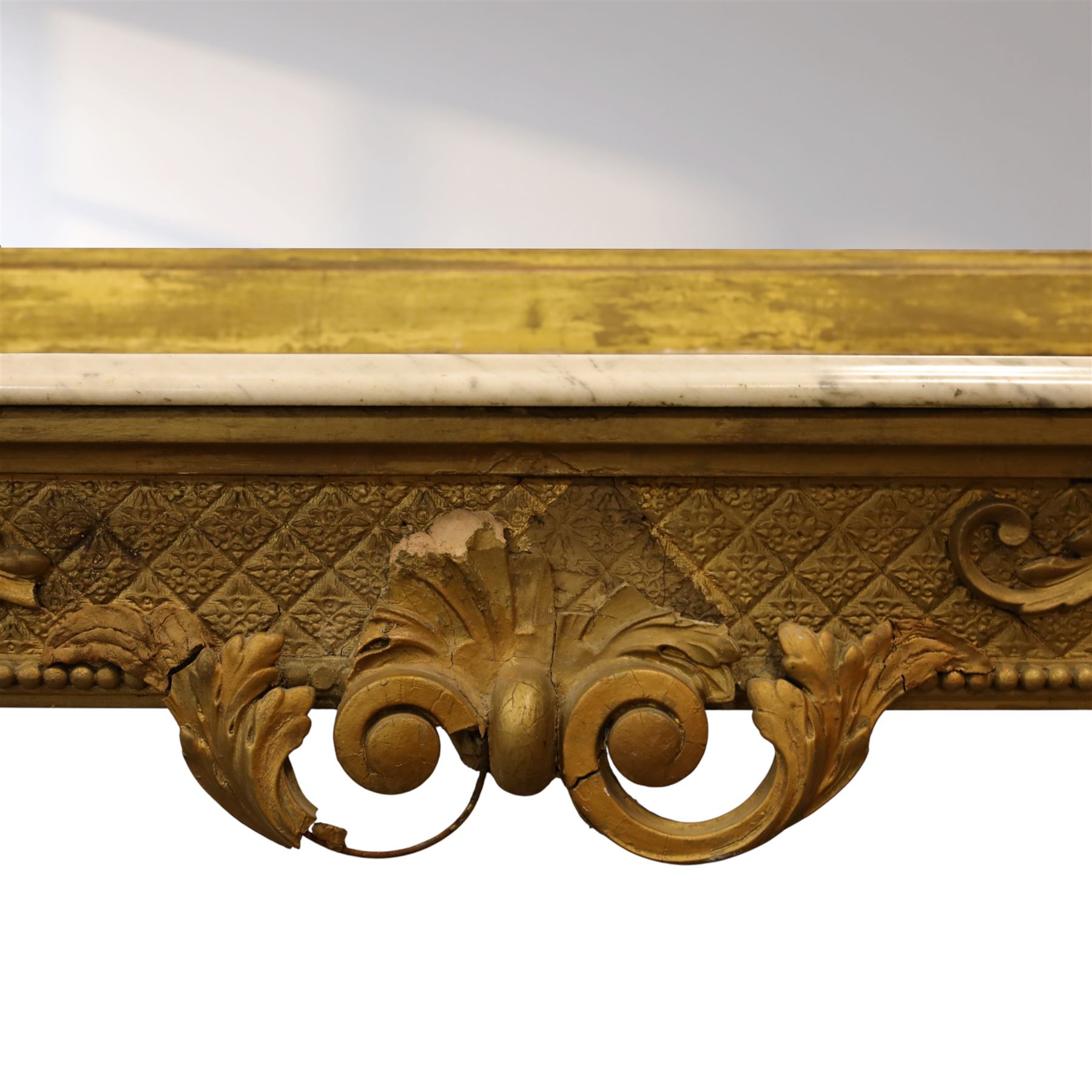 Large late 19th century Rococo revival giltwood and gesso pier mirror, the rounded rectangular frame with richly carved crest and scrolls with acanthus leaves and foliate ornamentation, above a giltwood console table with Carrara marble top and richly carved guilloche and ribbon tied laurel garland frieze, rosettes, and central scrollwork, raised upon tapered legs with beaded moulding and square block above with turned toupie style terminal  