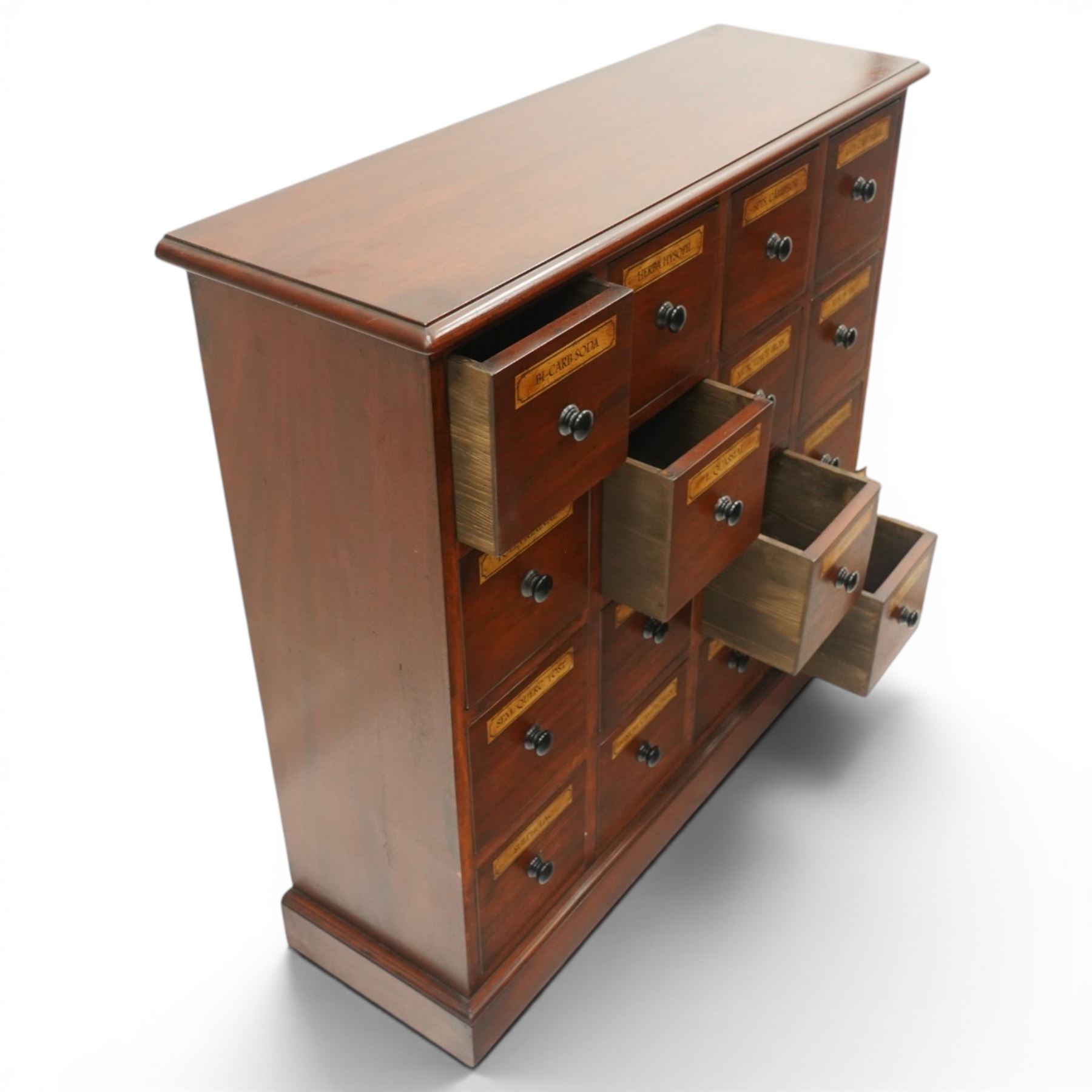 Victorian style mahogany stained chemist’s cabinet, rectangular moulded top over sixteen small drawers, each fitted with turned knob handle and applied gilt paper pharmaceutical labels, on moulded plinth base