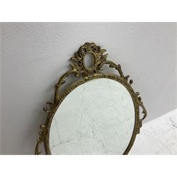Ornate brass wall mirror with oval plate, L78cm