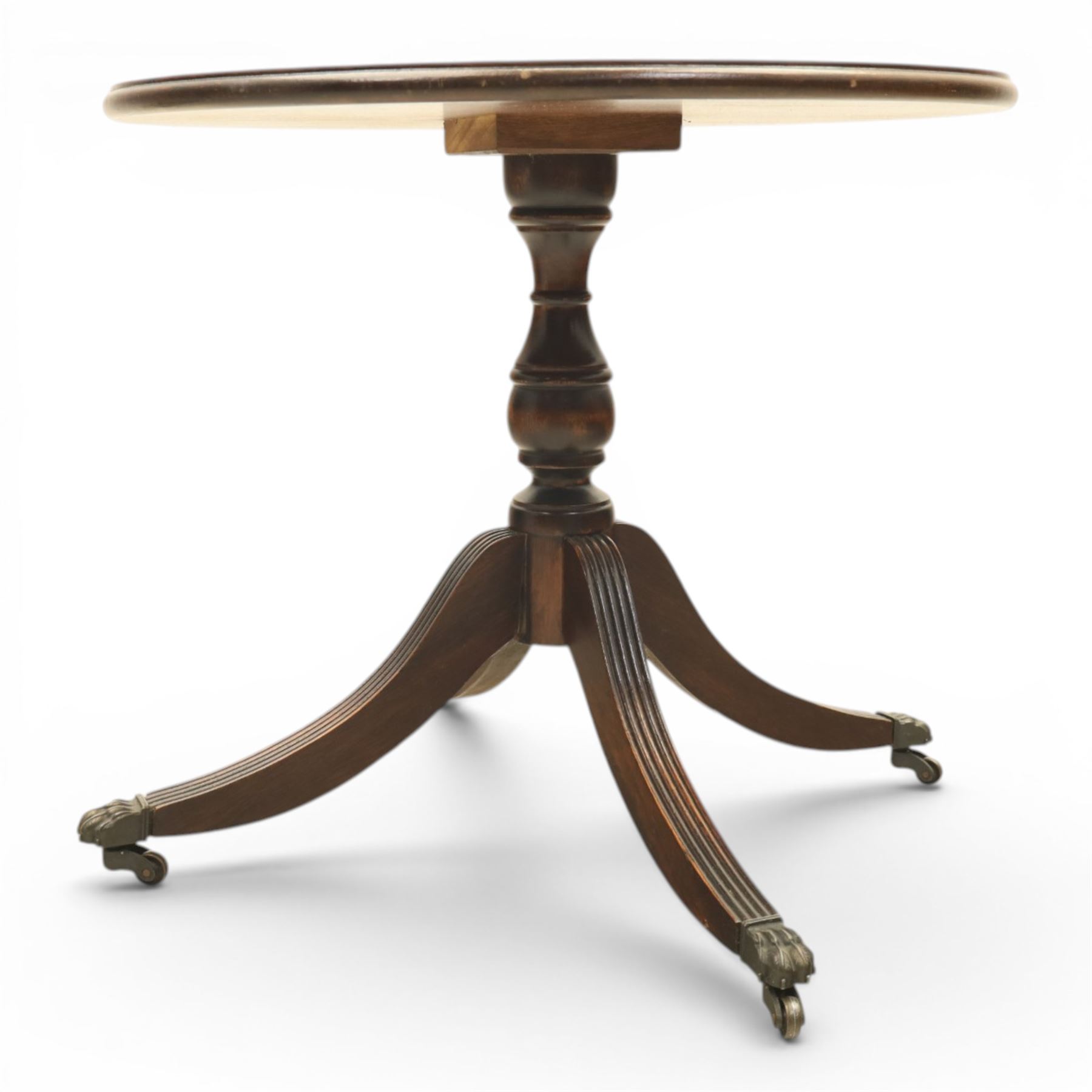 Pair of Georgian design flame mahogany wine tables, circular book-matched veneered tops with moulded edges, on turned pedestals and four reeded downswept supports terminating in brass caps and castors