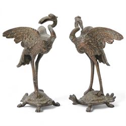 Pair of Japanese bronze figures, each modelled a crane atop minogame, H20cm