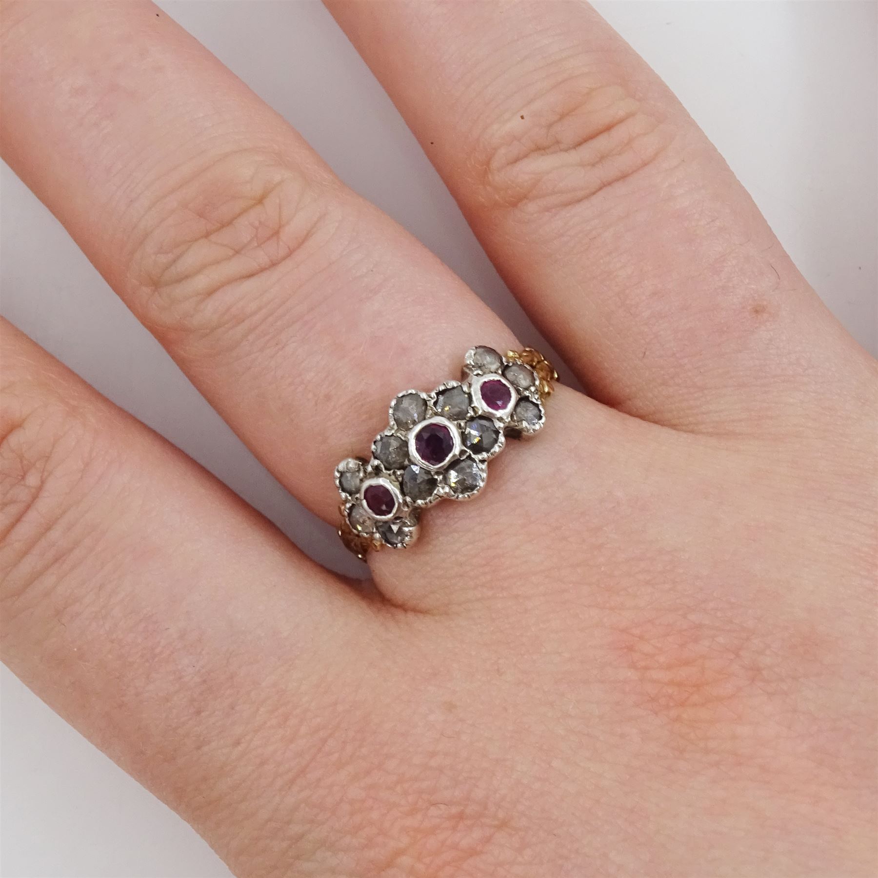 19th century 14ct gold and silver ruby and rose cut diamond flower head cluster ring, with foliate design shoulders