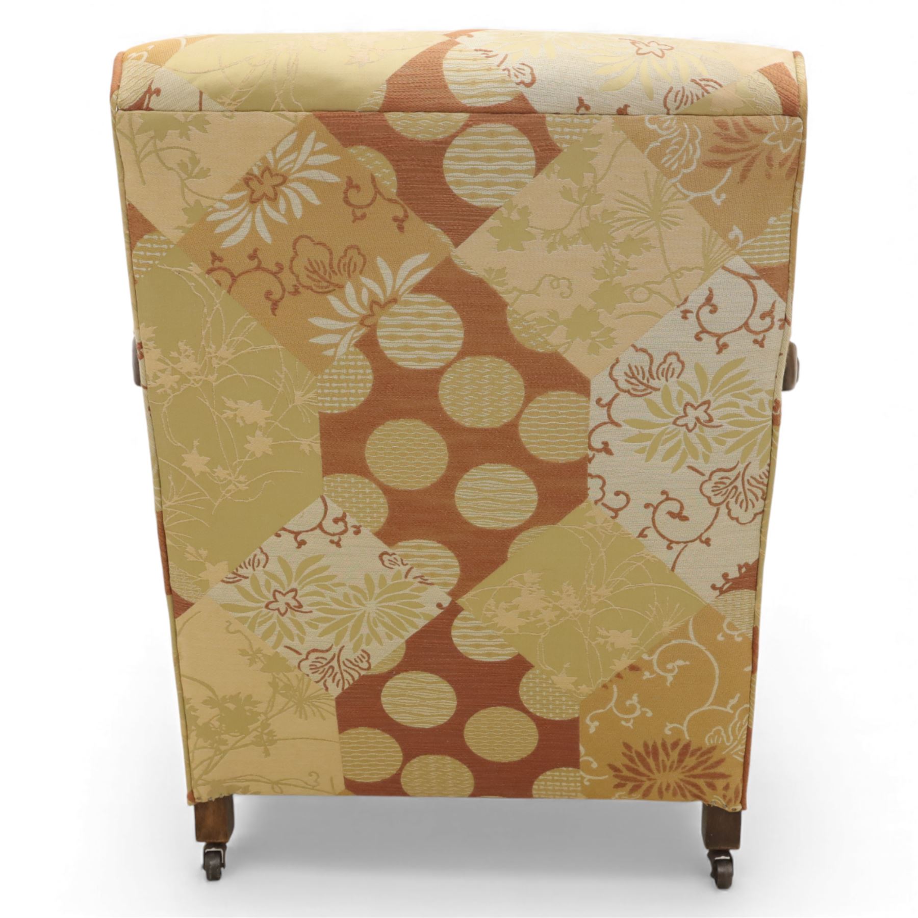 Pair of mid-20th century mahogany framed bergère armchairs, each with carved scroll arms and caned side panels, floral upholstered loose cushions, raised on cabriole front supports