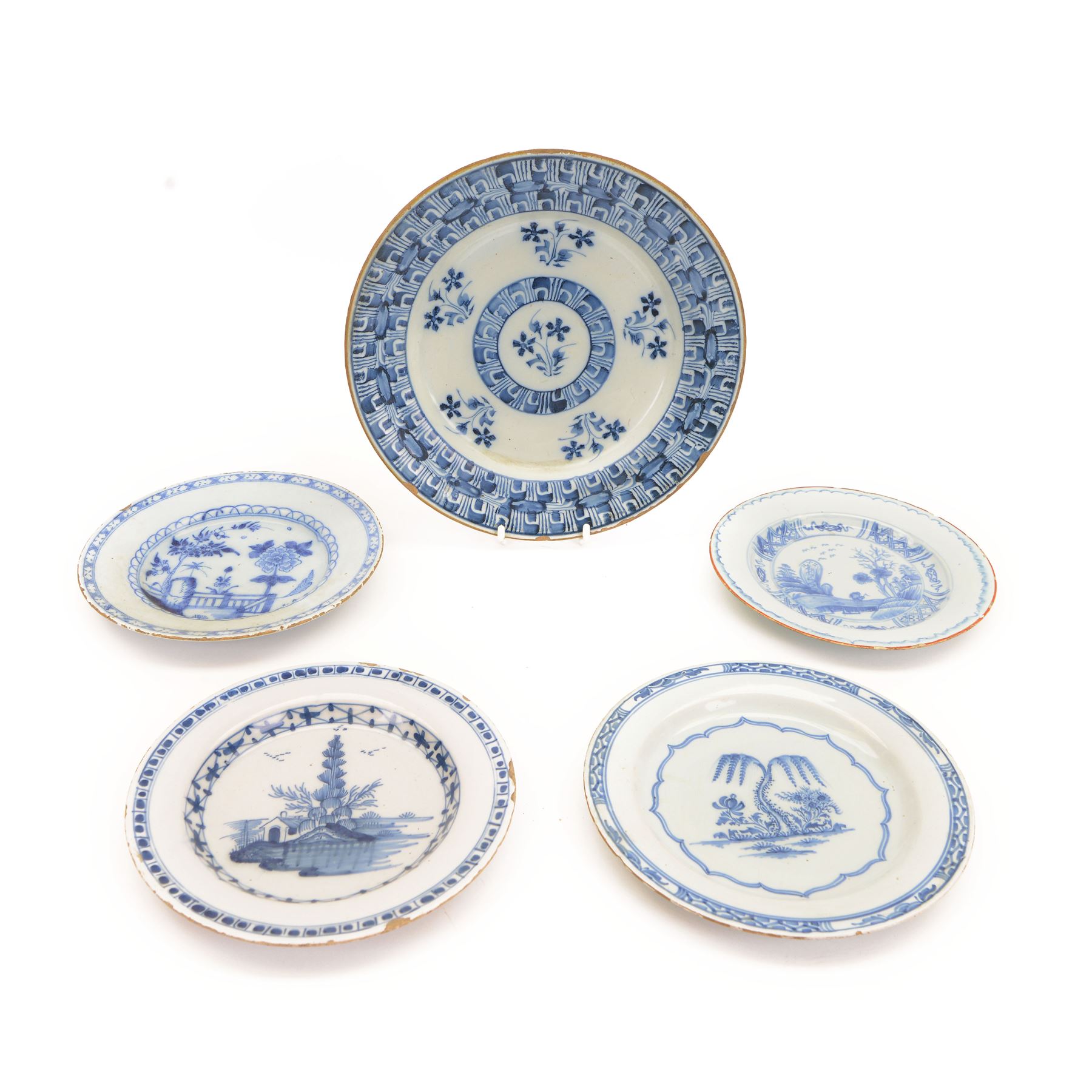Five 18th century blue and white English and Dutch Delft plates, to include an example probably by the Abigail Griffith Delftworks in Lambeth, London, circa 1765-1775, depicting a landscape scene with house and tree, contained within geometric borders, D23cm, largest example D30cm 