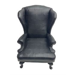 Wingback armchair, upholstered in black patch work fabric, on cabriole supports 