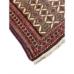 North East Persian Turkoman rug, ivory ground field decorated with repeating Gul motifs, multi-band border decorated with geometric patterns and motifs