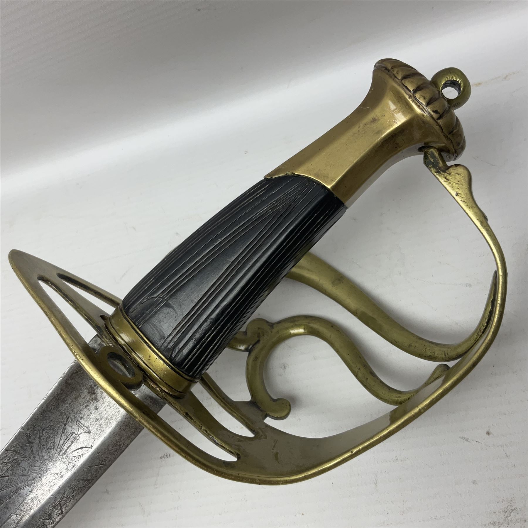 Late 18th century sword, the Spanish 79.5cm curving fullered blade engraved with the Royal Cypher, battle trophies and 'Viva Espania' banner, French Sabre de Mineur brass three-bar hilt with ebonised reeded grip L93.5cm overall (no scabbard)