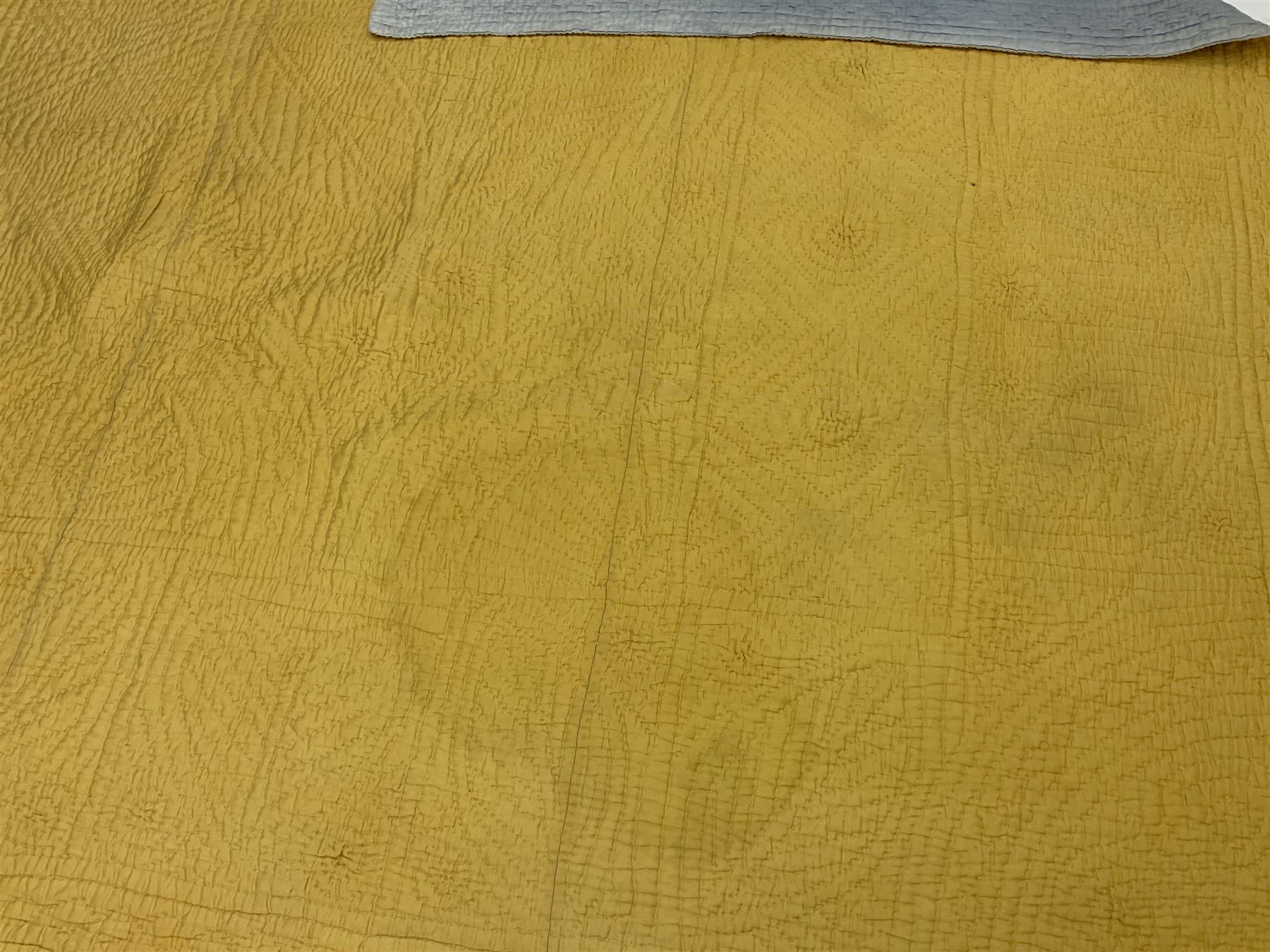 Early 20th century Welsh whole cloth sky blue quilt, in traditional quilting patterns, supported on yellow coloured backing, 174cm x 204cm