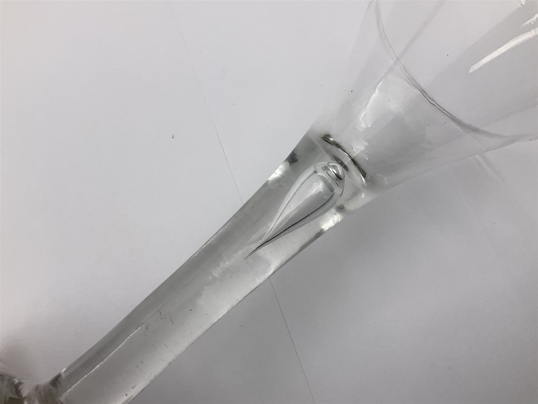 18th century wine glass, the trumpet shaped bowl upon tear drop stem and conical folded foot, H15.5cm, together with an 18th century cordial glass, the round funnel bowl on plain knopped stem and folded conical foot