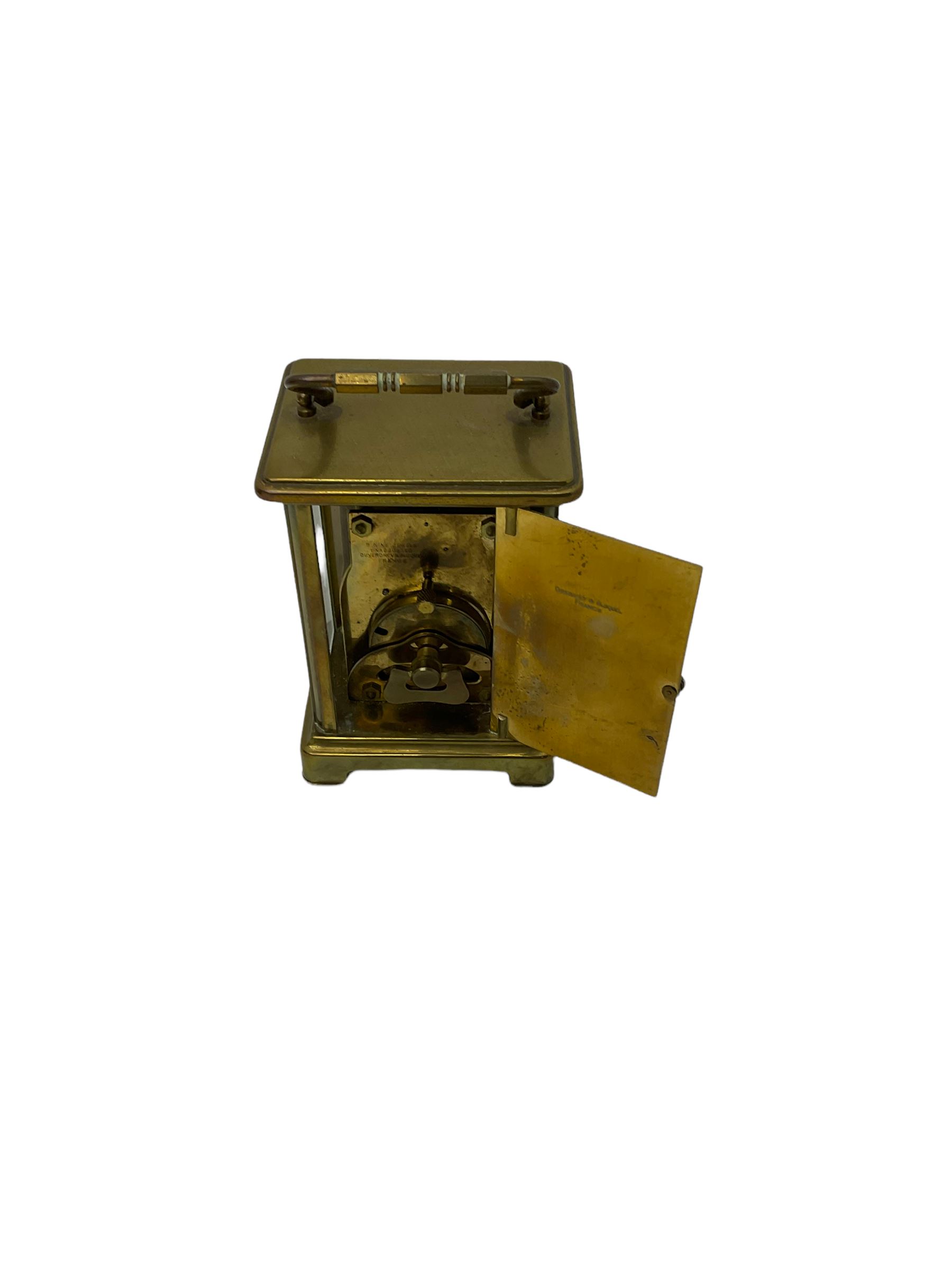 A French carriage clock by Duverdrey & Bloquel c1920, with three glass panels and white enamel dial, Roman numerals and minute markers, lever platform escapement and integral winding key. Together with a late 19th century American spring driven 30hr alarm clock by Seth Thomas of Connecticut USA c1890, in a wooden case with a white dial and brass alarm setting disc.   


