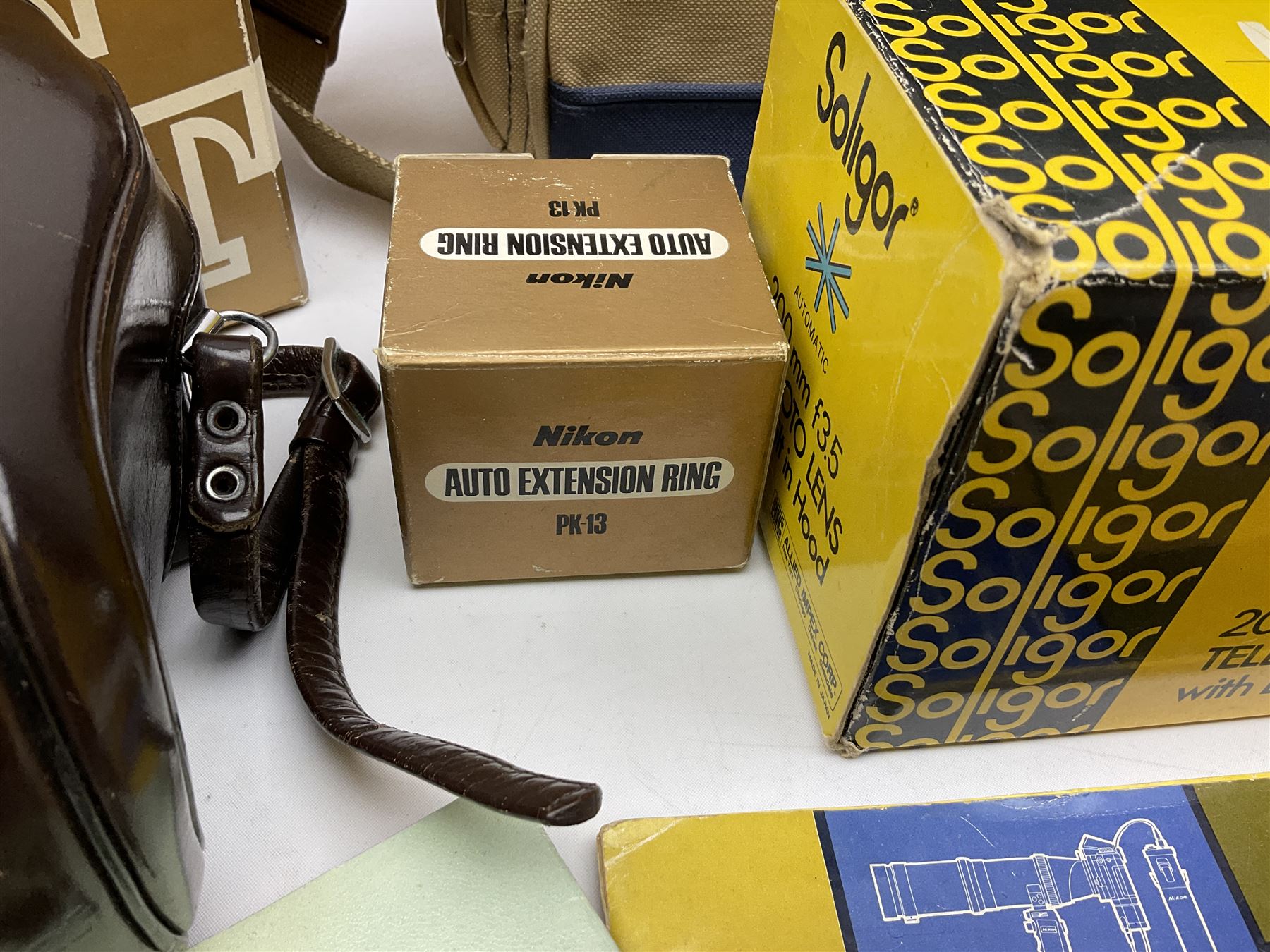 Cameras and accessories including Nikon Nikkormat camera with ‘Nikkor-H 1:2 f=50mm’ lens, Olympus C-8080 wide zoom digital camera, soft case camera bag etc, all untested, in one box