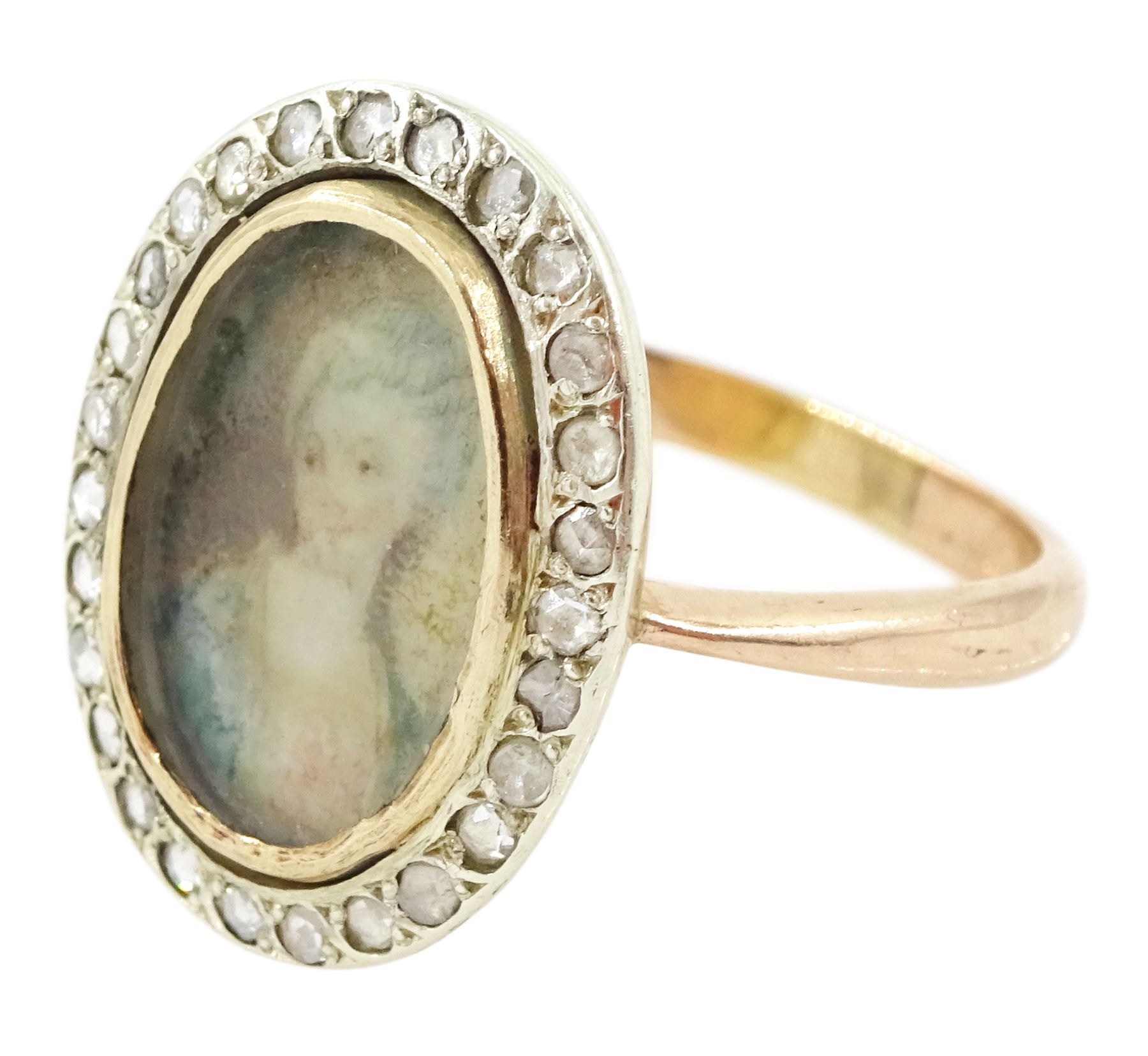 19th century 9ct gold diamond portrait ring, set with an oval miniature of a woman in 18th century dress on ivory, under a glazed panel, with rose cut diamond surround, on later shank. This lot has been registered for sale under Section 10 of the APHA Ivory Act