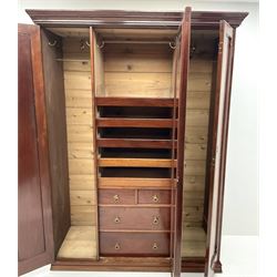 Victorian mahogany triple wardrobe, central mirrored door enclosing linen slides and two short and two long drawers flanked by two cupboards, plinth base